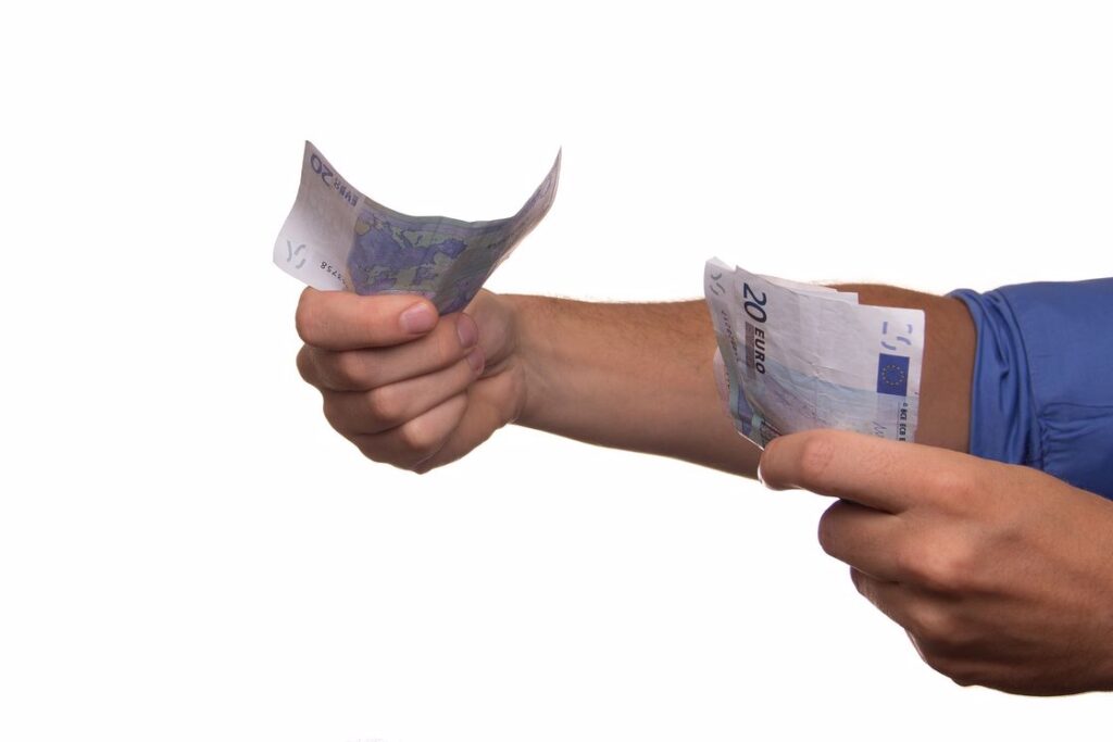 Person handing out bank notes