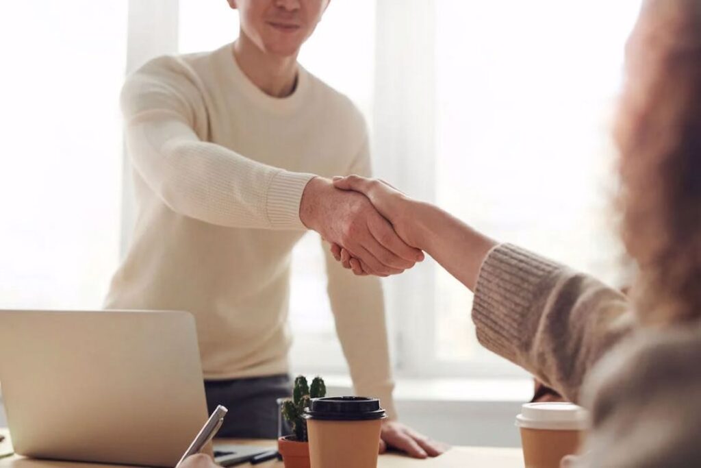 Man shaking hands with a woman in agreement