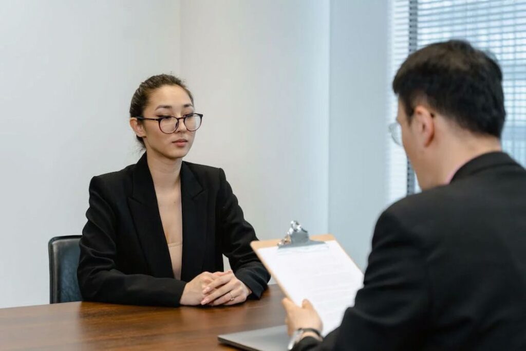 Woman listening intently while a man is reviewing her resume