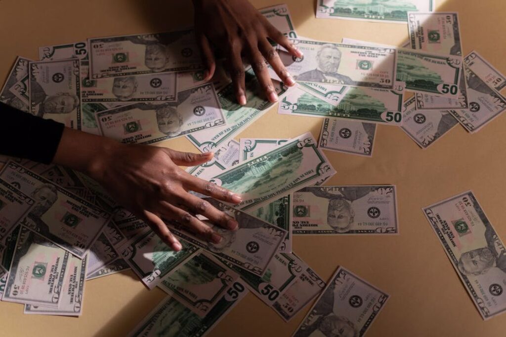 Hands arranging the dollar bills on the table