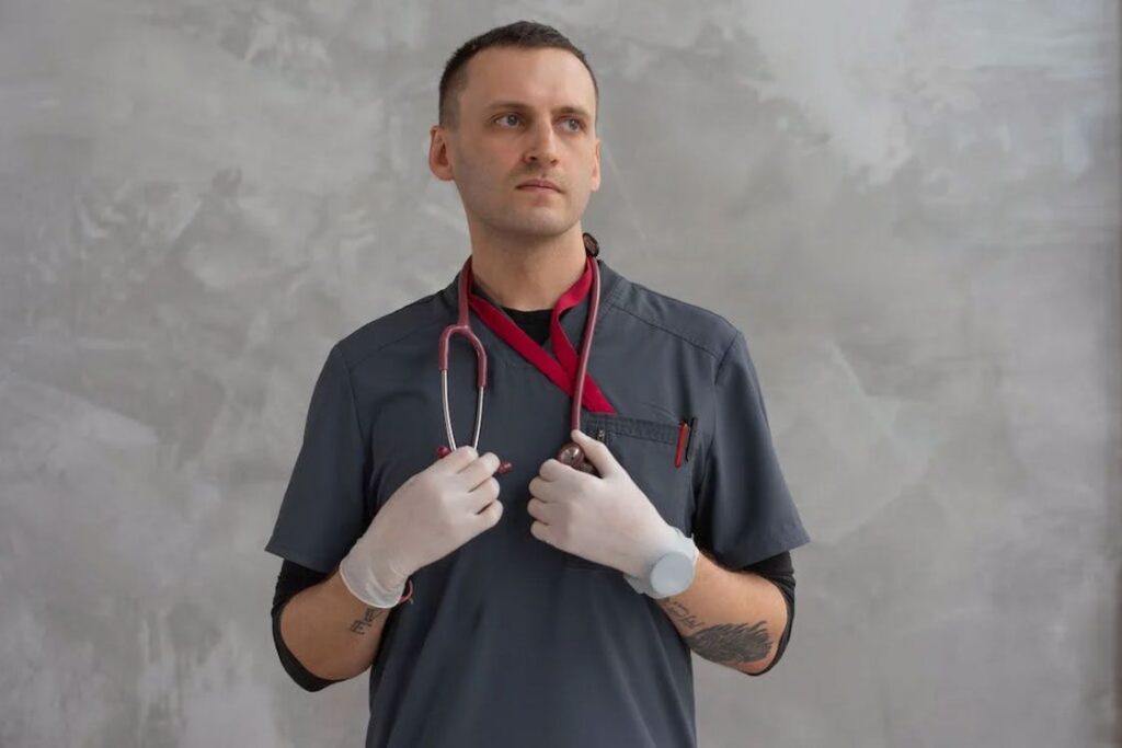 Veterinarian wearing white gloves, scrubs and stethoscope