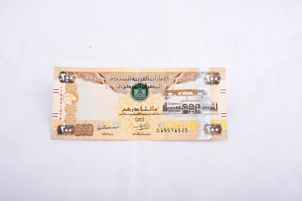 A 200 United Arab Emirates dirham bill was placed on a white surface
