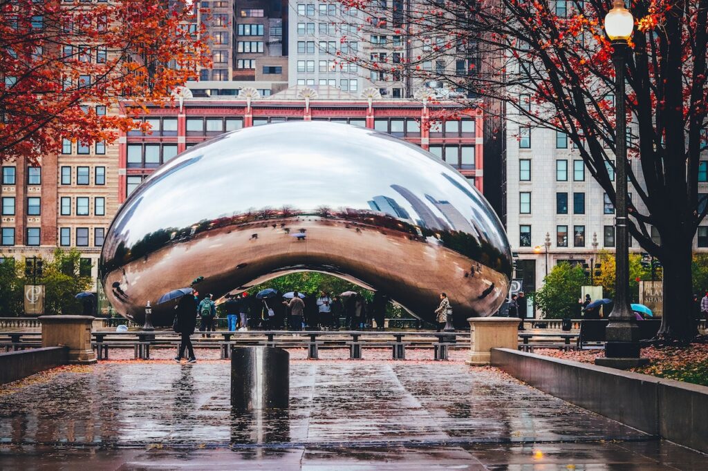 In a tourist spot in Chicago which is called The Bean a polished metal piece casts a wide-angle reflection of the downtown skyline