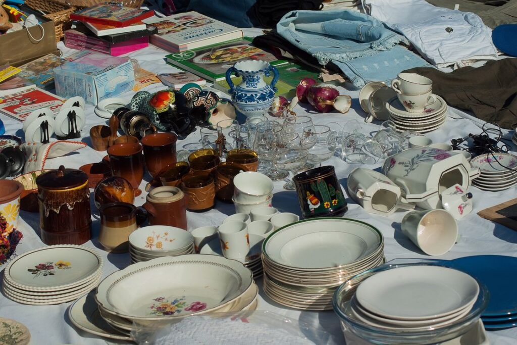 Plates and cups among other things for sale in a flea market