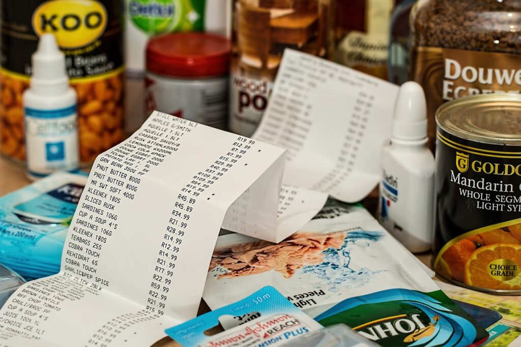 A long grocery receipt with some items on its background