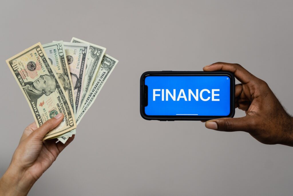 A man holding some cash and a man holding a phone with the word finance