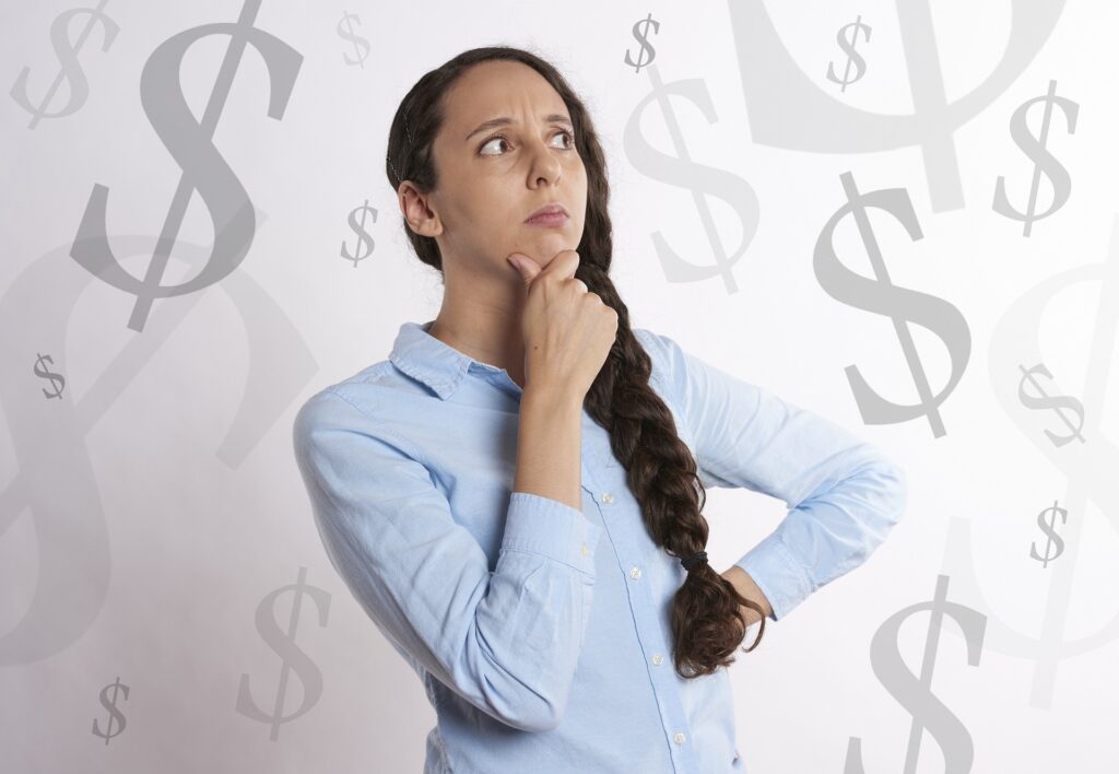 An image of a woman thinking with dollar signs as background