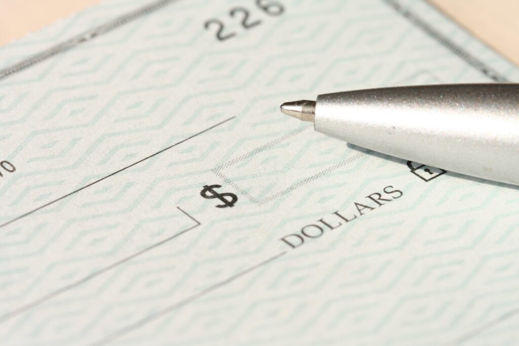 An image of a check with a pen