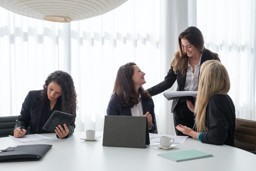 Four women in an office after meeting